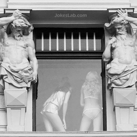 funny statue staring at  sexy girls 
